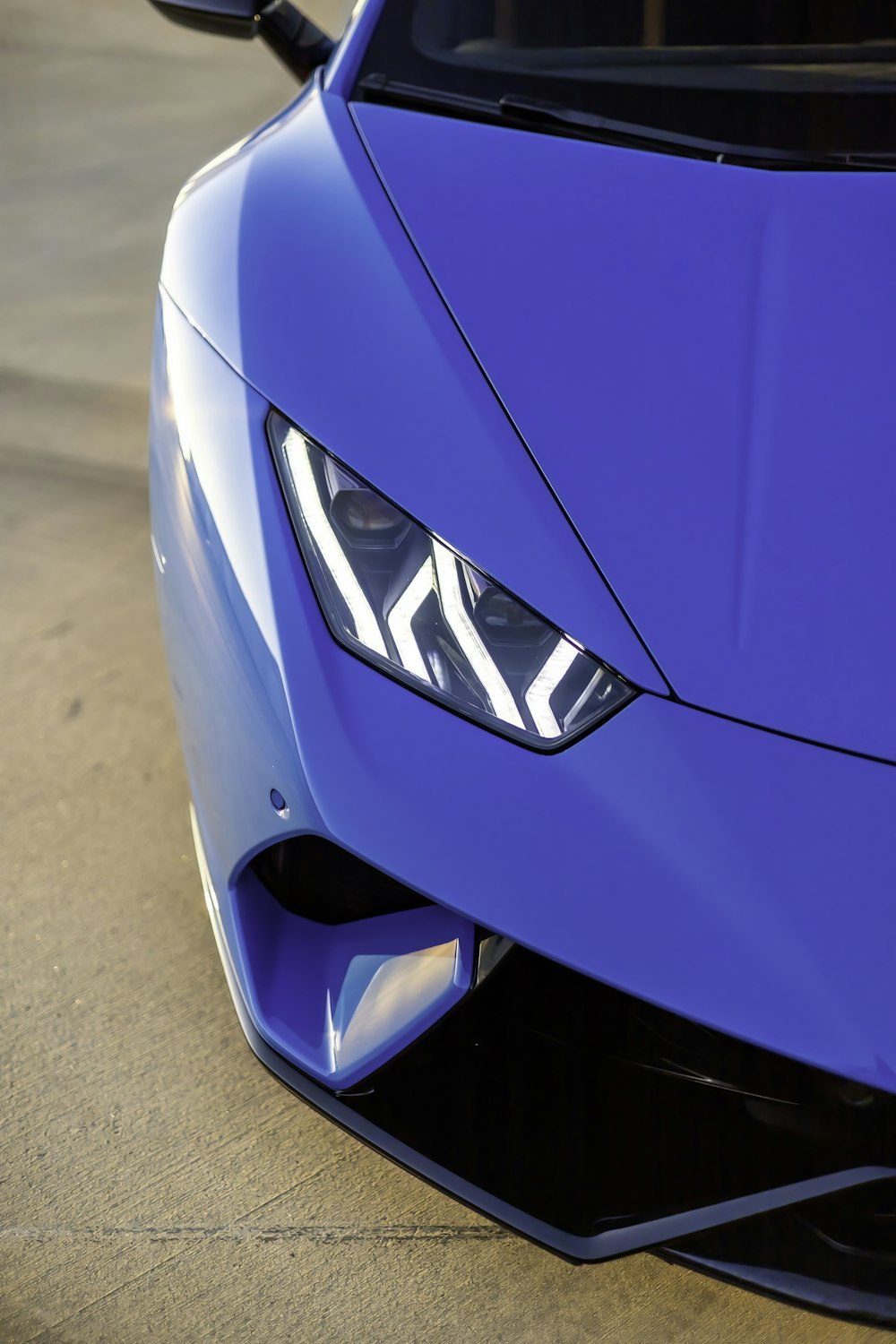 a close up of the front of a blue sports car