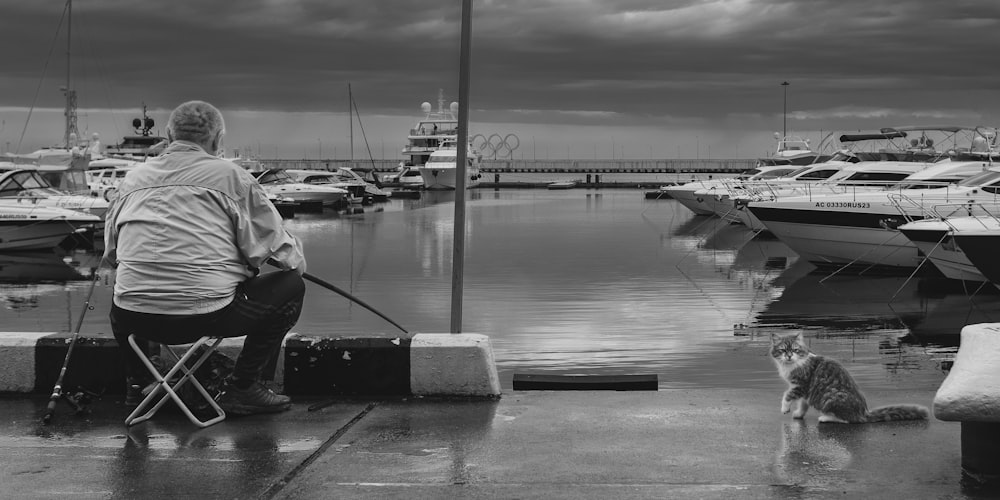 a man sitting on a bench next to a dog