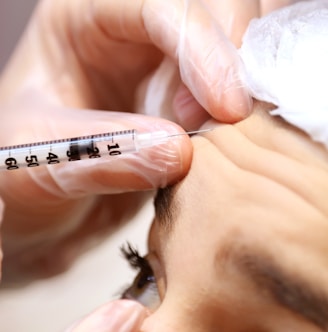 a woman getting her eyebrows examined by a doctor