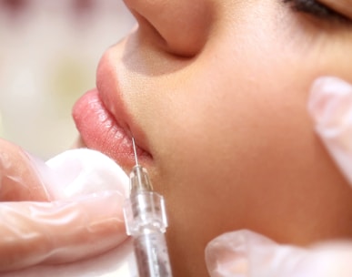 a woman getting a botilage injection from a doctor