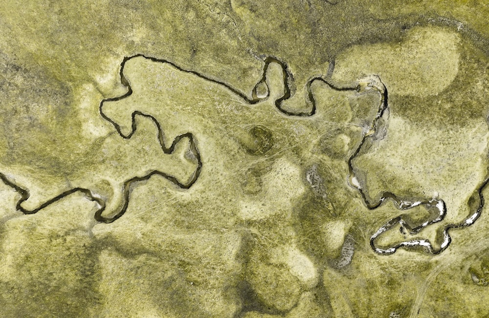 an aerial view of a river in the middle of a field