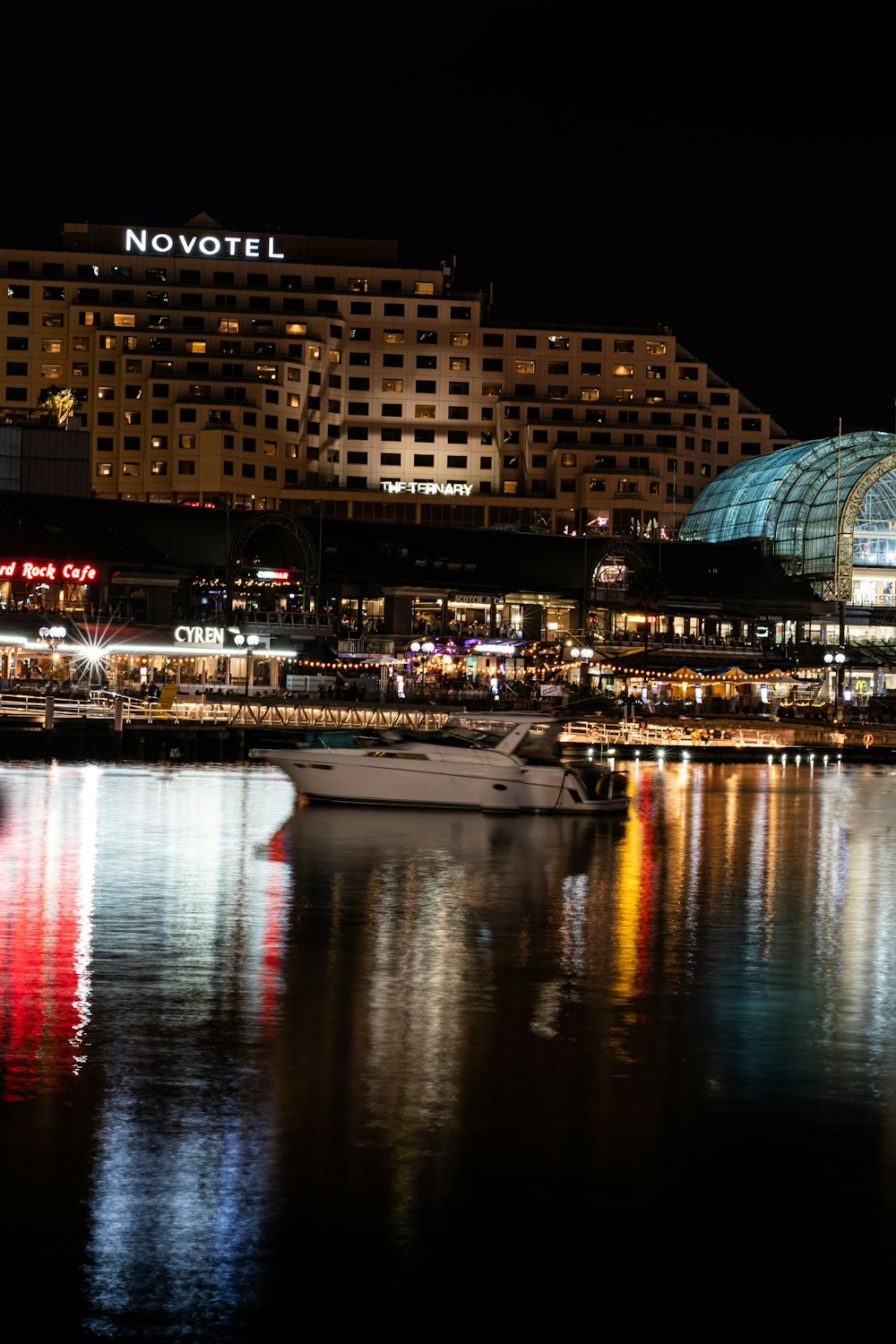 a boat is docked in a harbor at night