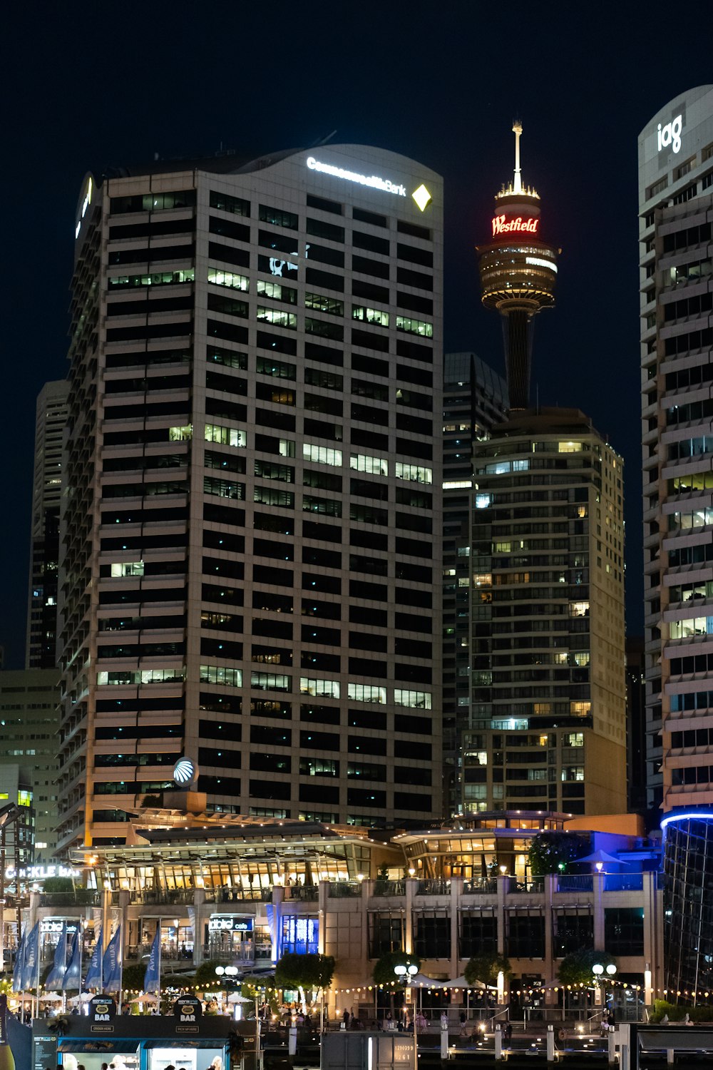 a city skyline at night with tall buildings