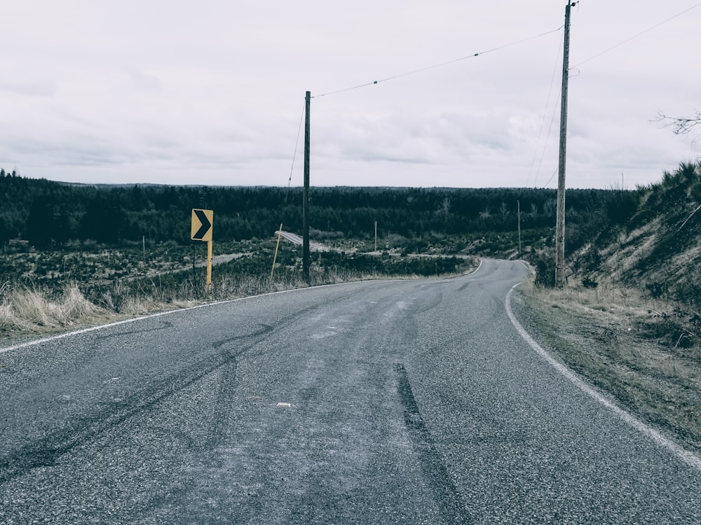 a road with a yellow sign on the side of it