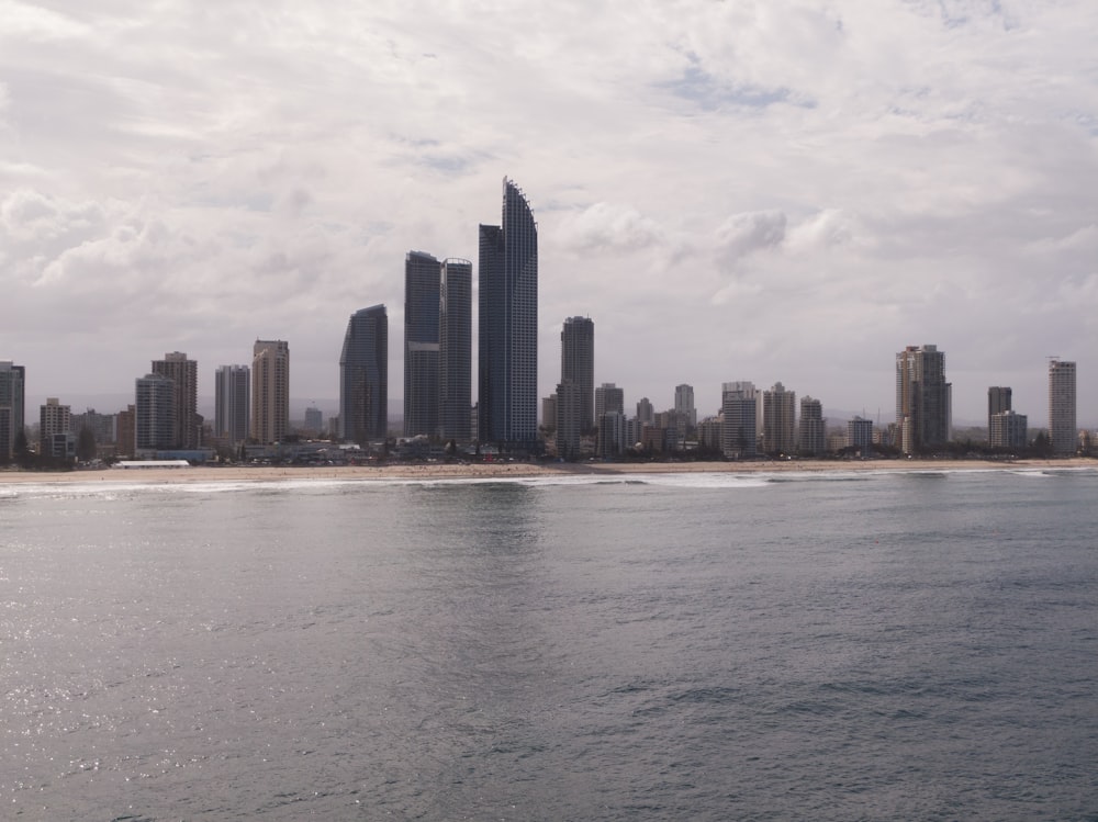 a large body of water with a city in the background