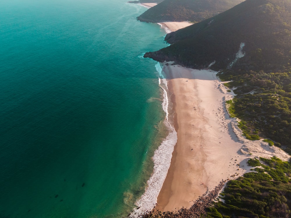 an aerial view of a sandy beach near the ocean