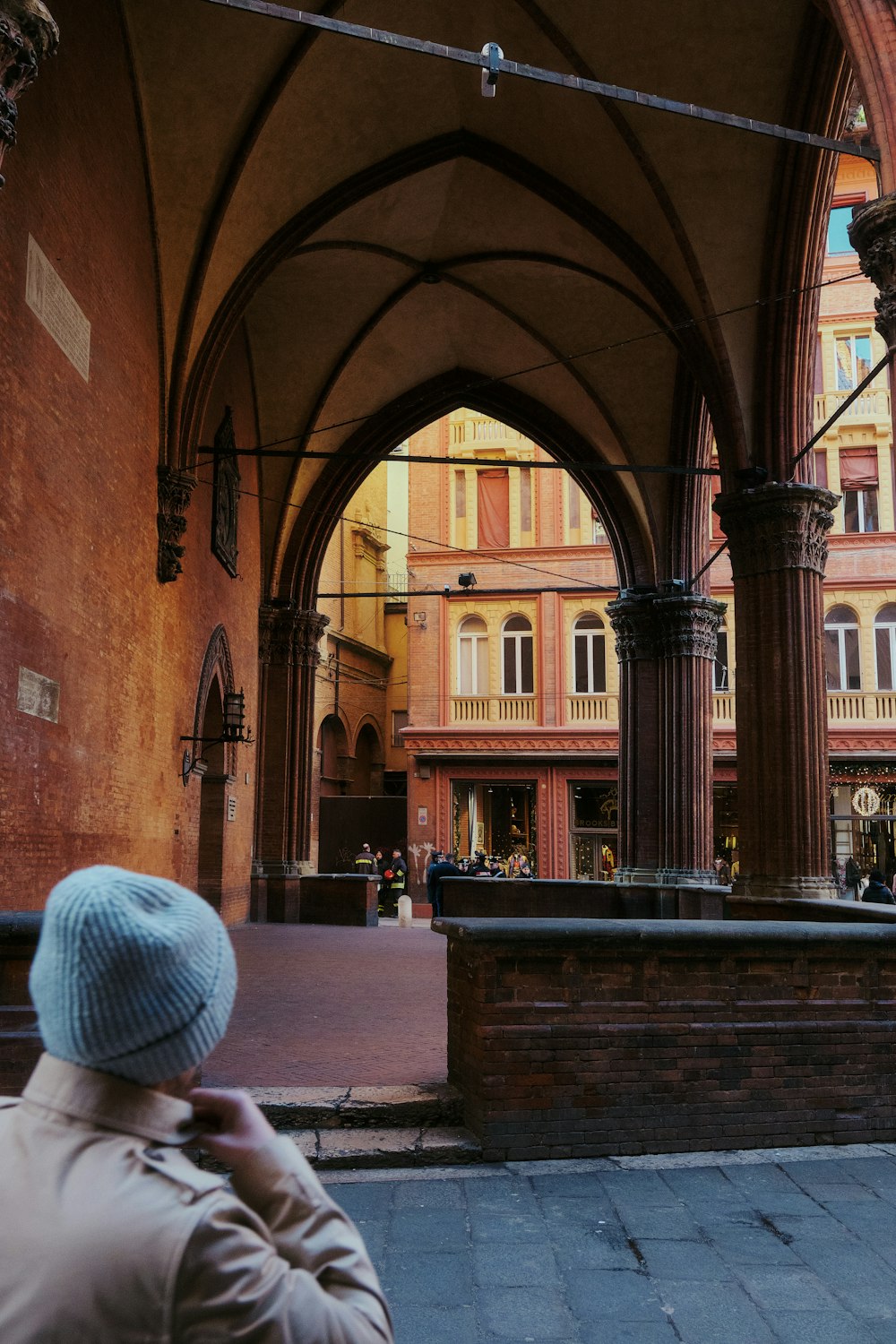 a person in a blue hat standing in front of a building