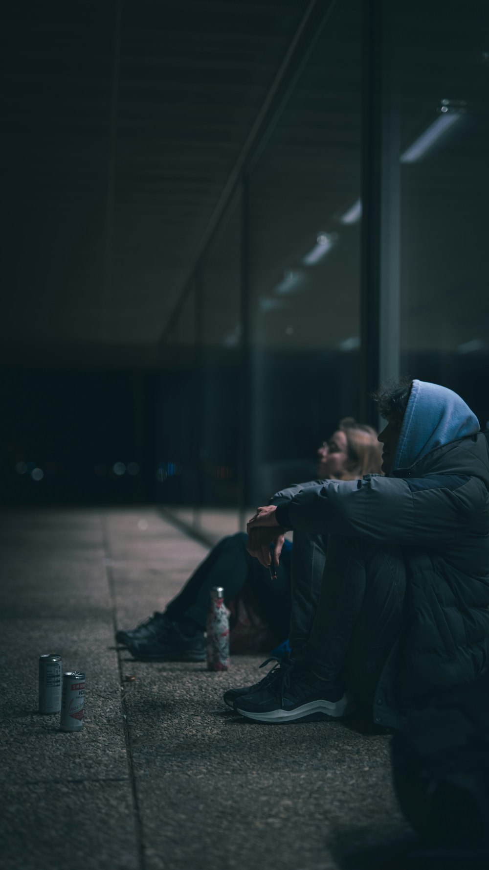 a couple of people sitting on the ground next to each other