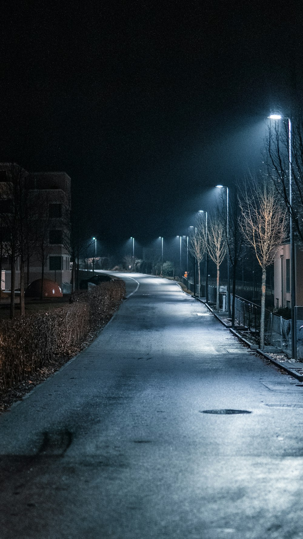 a dark street at night with street lights