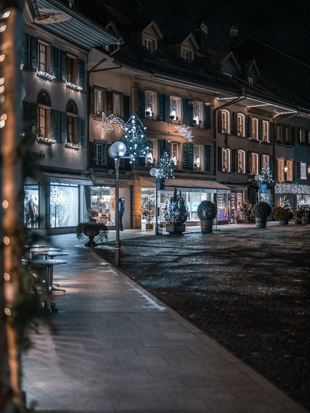 a city street at night with christmas lights