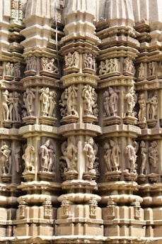 a close up of a building with statues on it