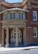 An entrance to a brick building with a rounded portico labeled 'Children's Court'. The structure features tall columns and an arched doorway with glass panes. A sign reading 'Albion St' is visible, along with a wheelchair accessibility symbol.