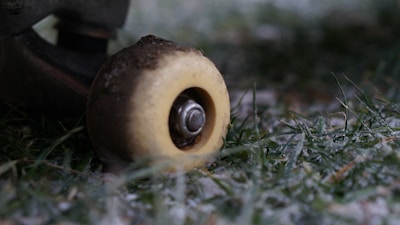 A close-up of a skateboard wheel rolling on a smooth surface, symbolizing movement and progress.