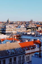A panoramic view of a European cityscape with various digital hospitality signs and smart devices.