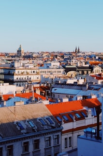 A panoramic view of a European city skyline with historic and contemporary buildings.