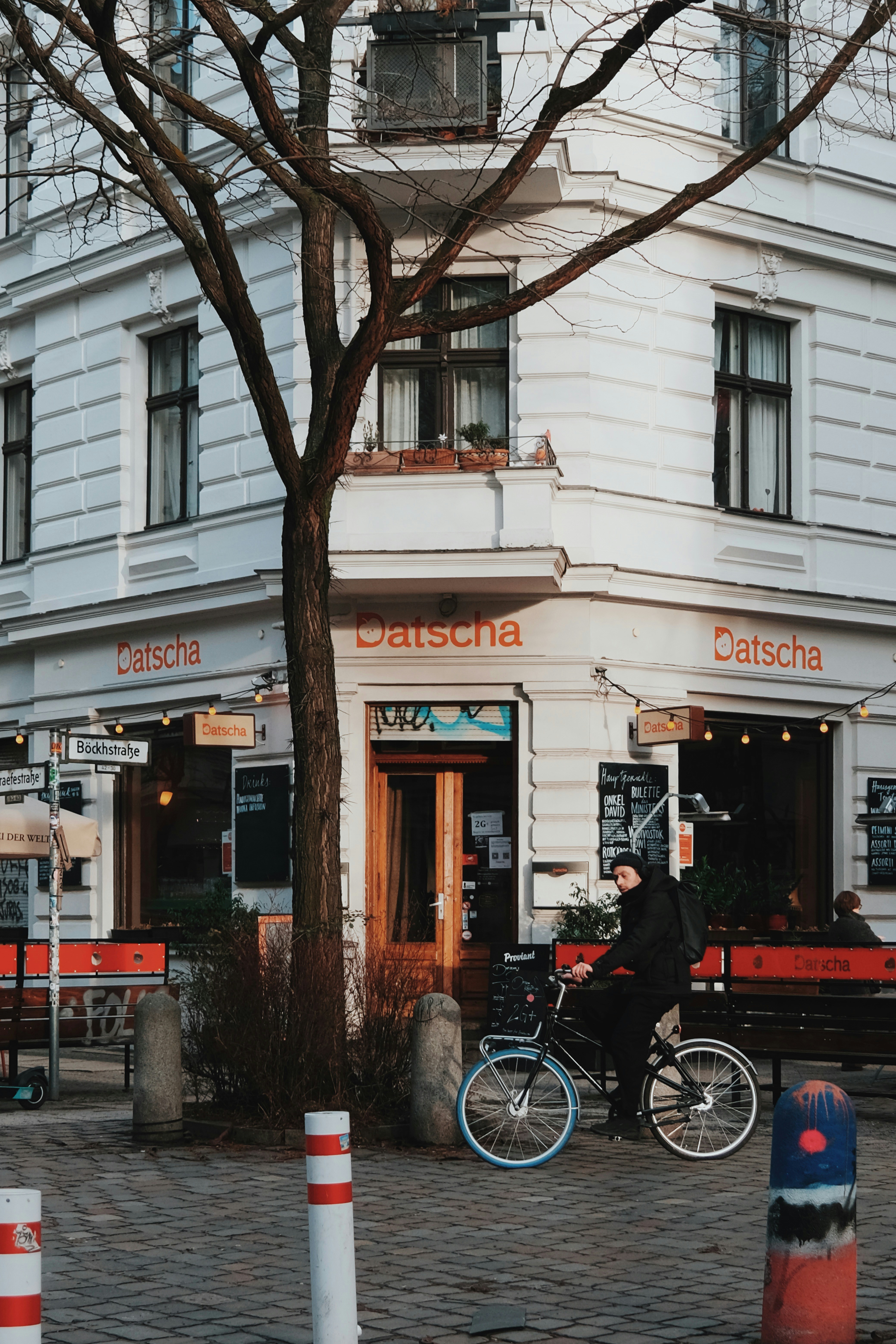 a person riding a bike in front of a building
