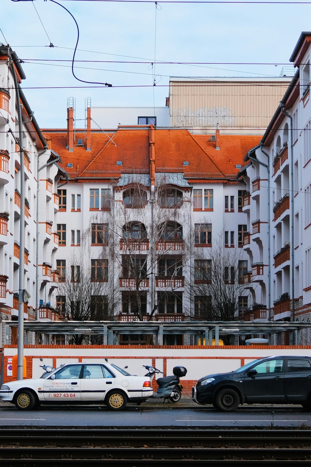 a couple of cars that are parked in front of a building