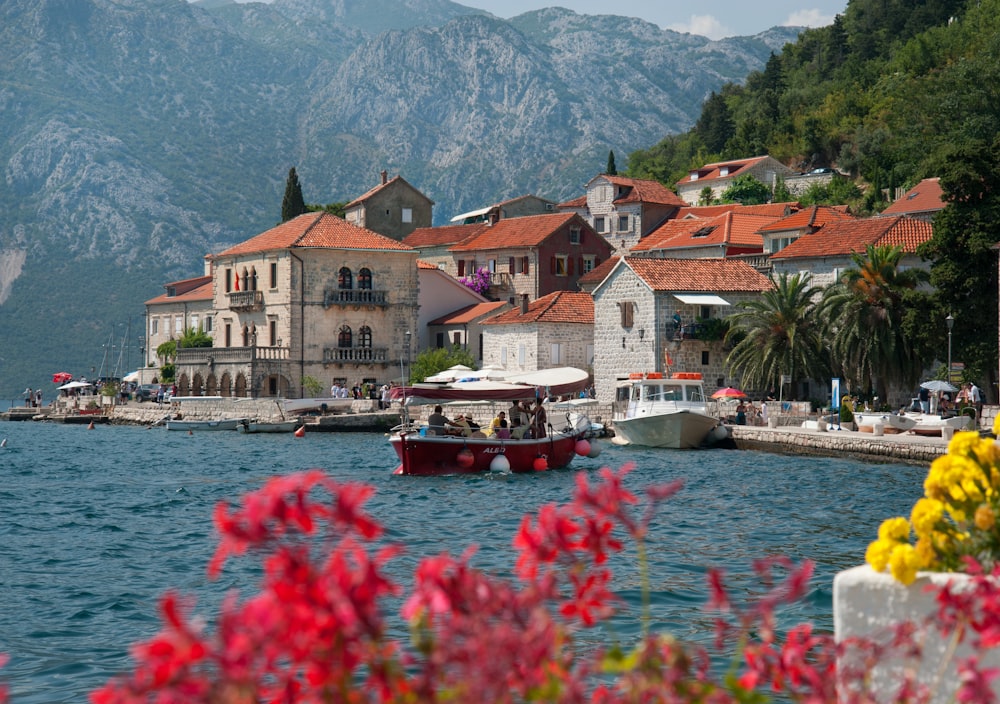 a boat in a body of water near a town