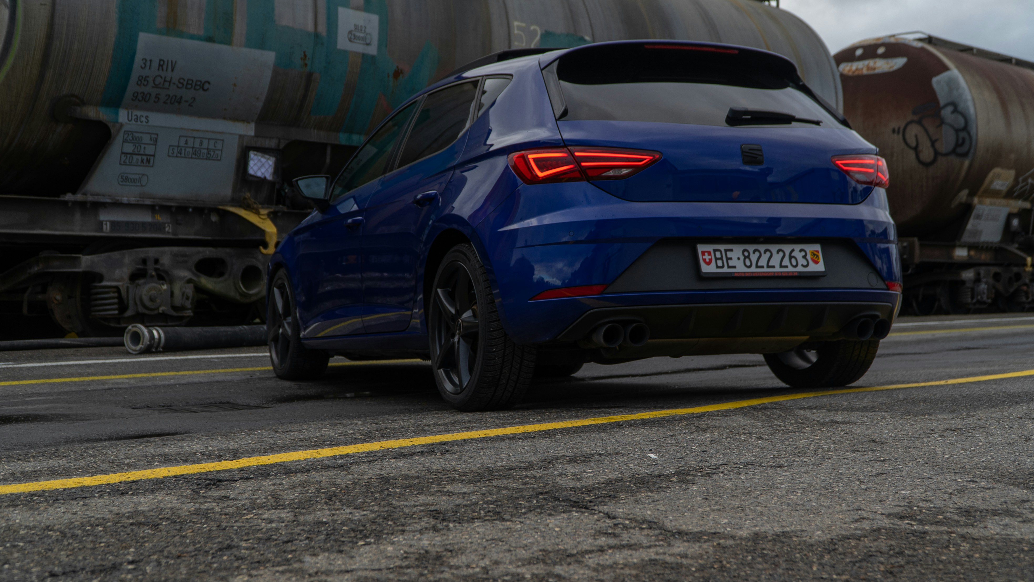 a blue car parked on the side of the road