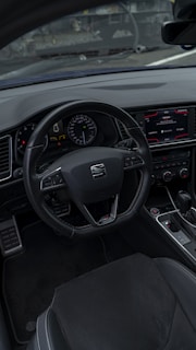 Interior shot of a car dashboard featuring modern controls and leather seats