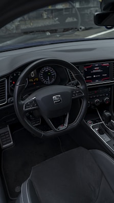 Interior shot showing a modern dashboard and leather seats of a used car.