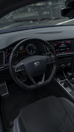 Interior shot showing the modern dashboard and leather seats of the car.