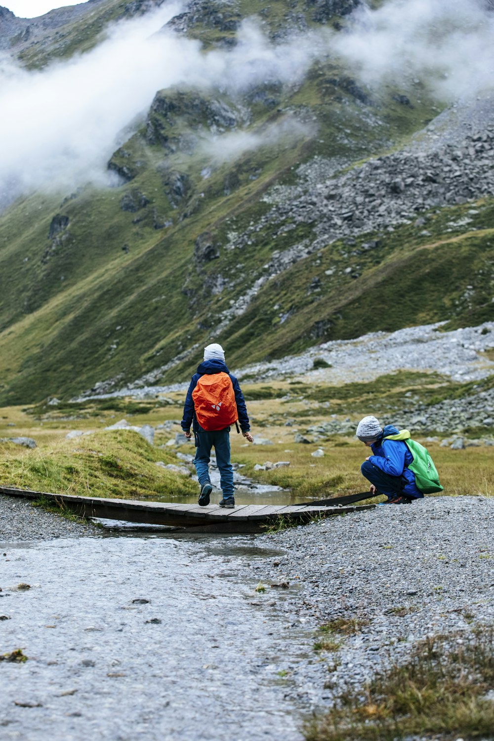 a couple of people walking across a bridge