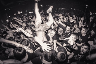 a crowd of people at a concert with a man in the middle of the crowd