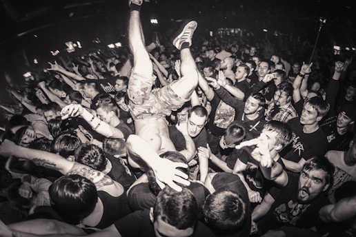 a crowd of people at a concert with a man in the middle of the crowd