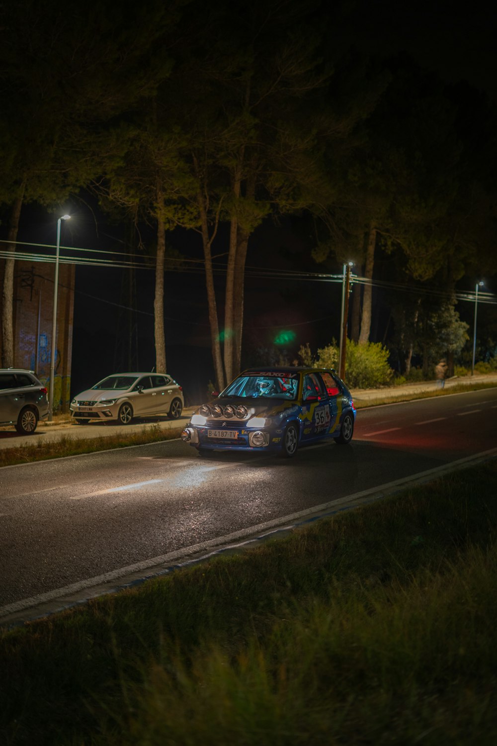 a car driving down a street at night