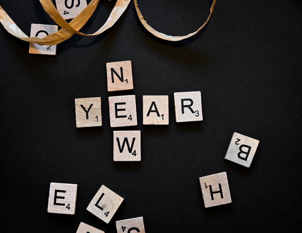 scrabble tiles spelling out the word new year