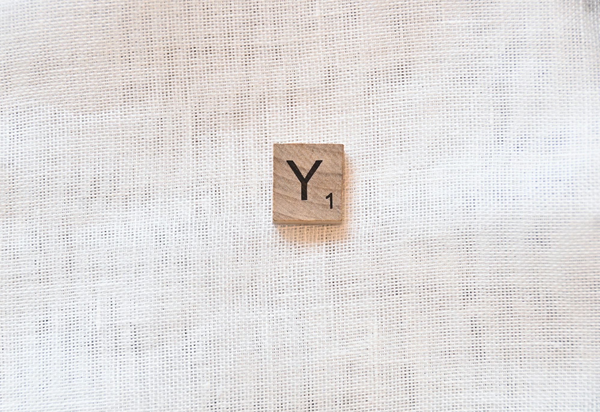 a wooden block with the word y on it