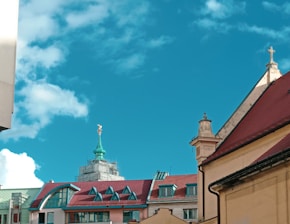 A vibrant collage of diverse church buildings from different continents under a bright sky.