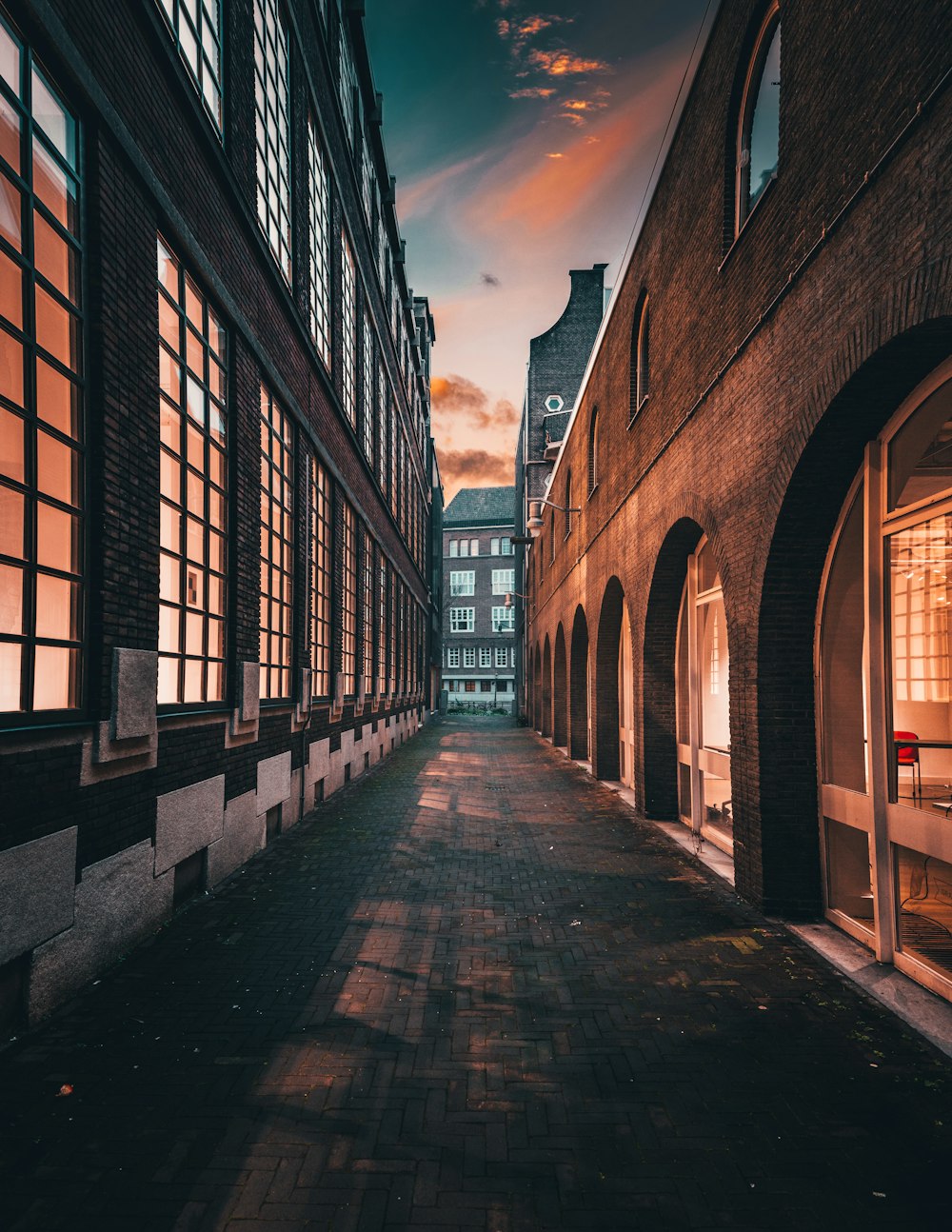 a street lined with tall brick buildings under a cloudy sky