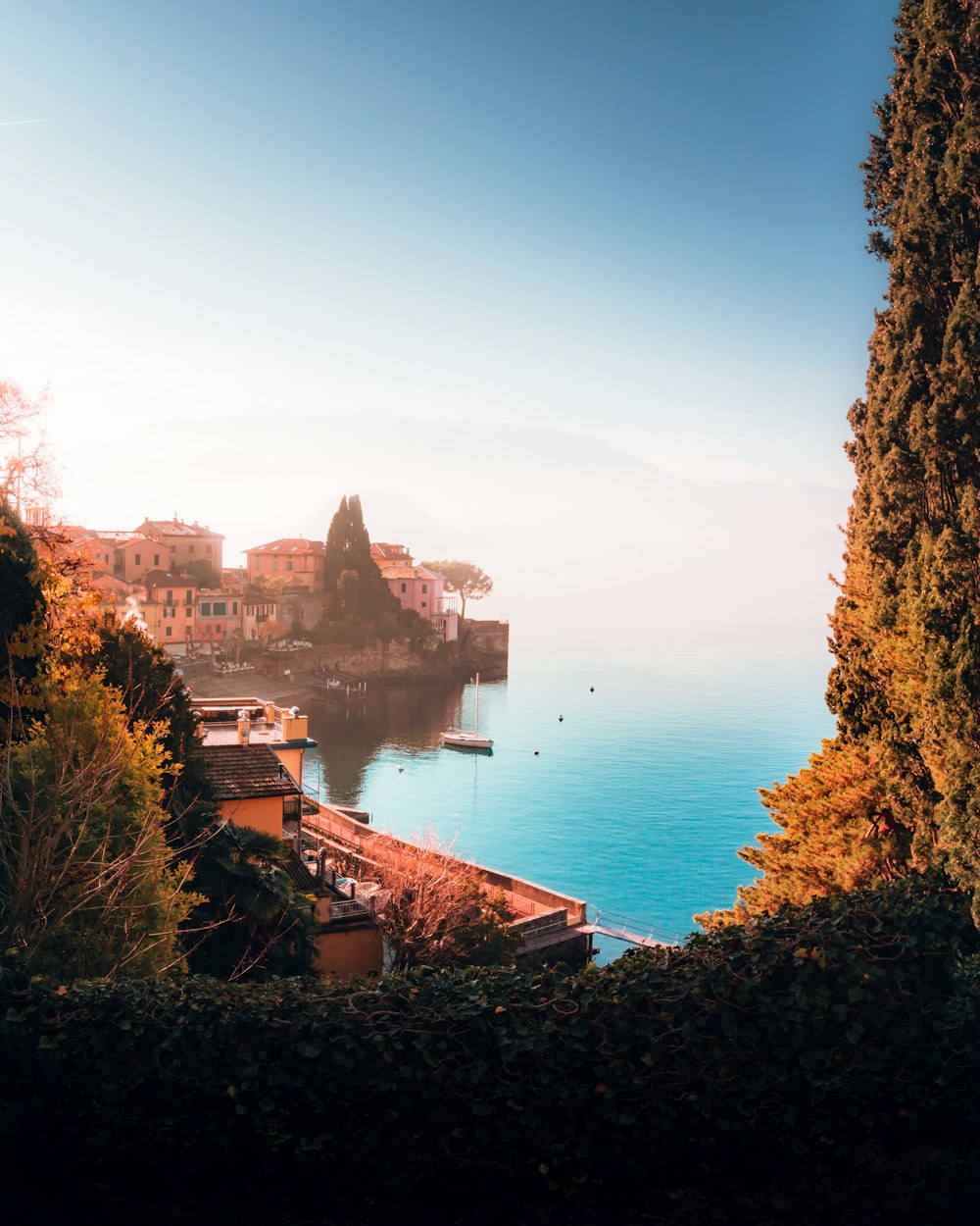 a body of water surrounded by trees and buildings