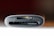 A close-up view of a card reader with slots labeled SD and TF, showing the edges of the slots in a dark gray finish. The background is blurred with warm, dark tones.