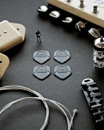 Sketches of mechanical parts integrated with guitar components.