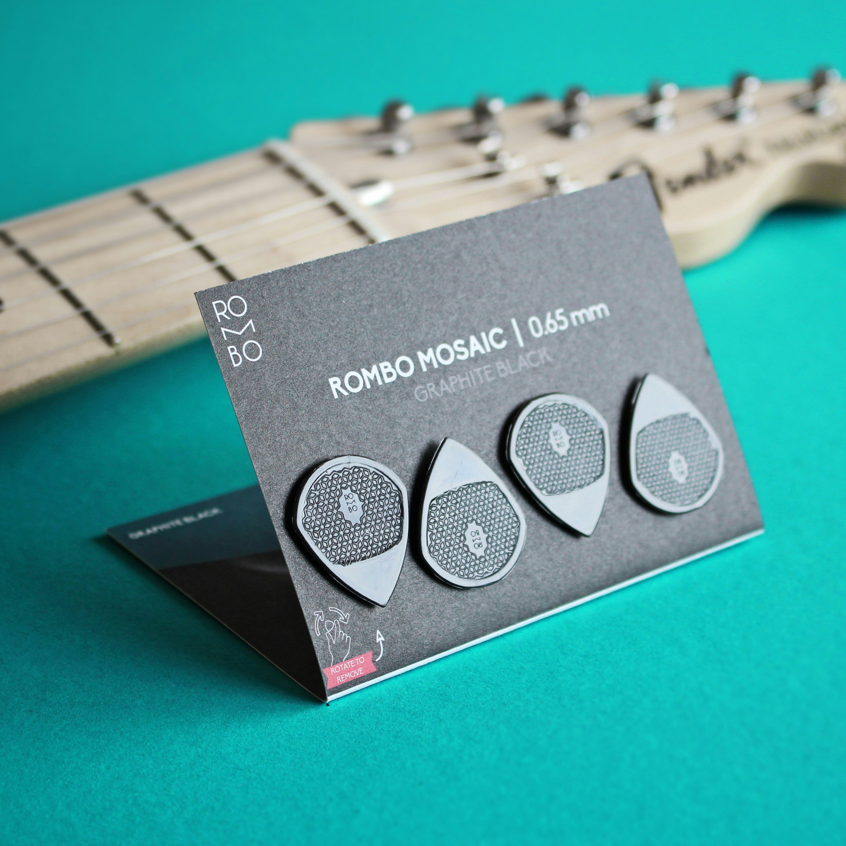 a close up of a guitar picker near a guitar