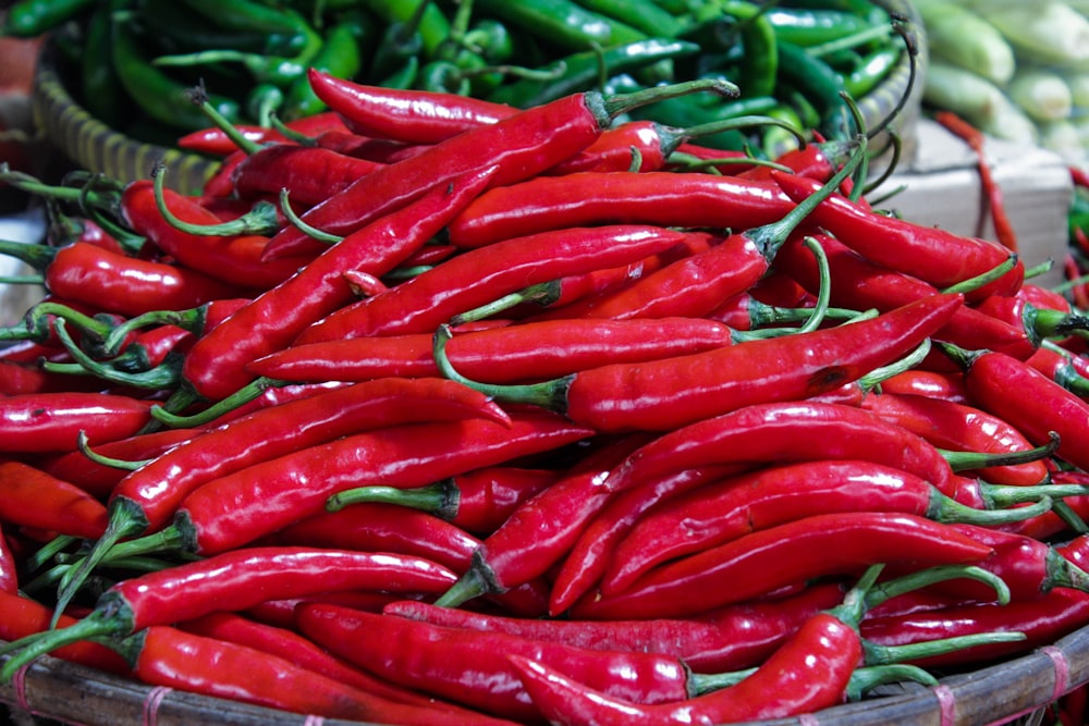 a basket full of red peppers sitting on a table