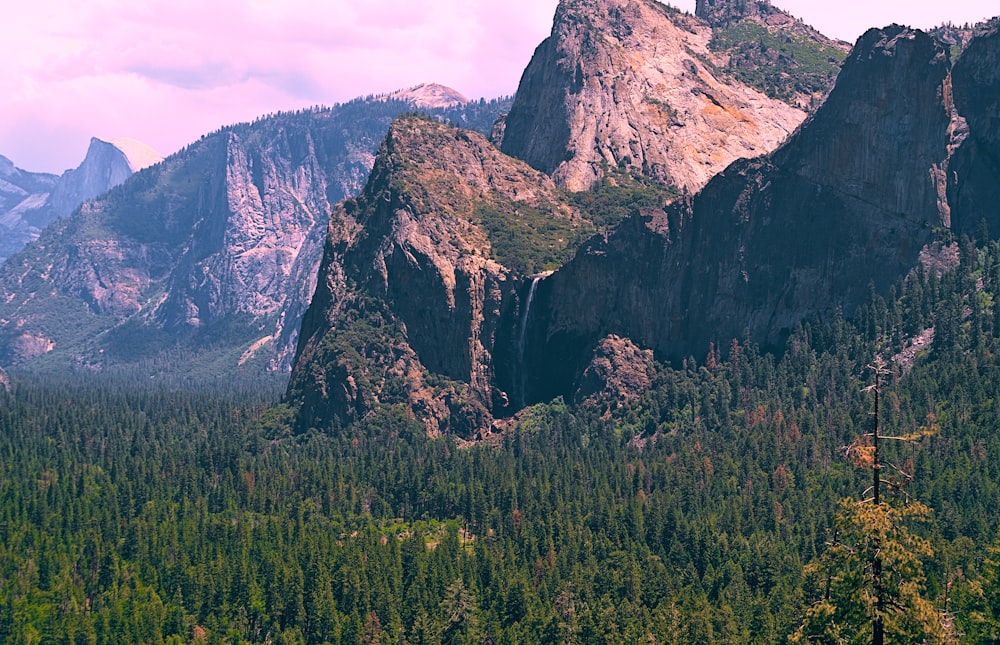 a mountain range with trees and mountains in the background