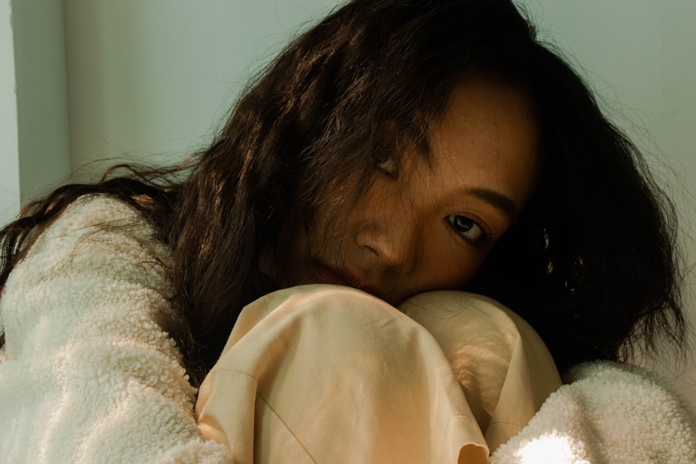 a woman with long hair and a white jacket