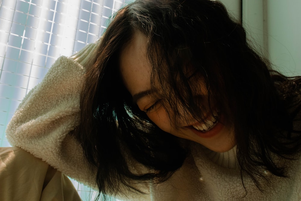 a woman with her hair in the wind