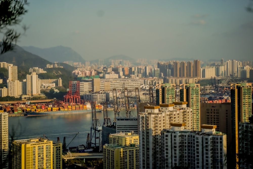 a view of a city with a harbor and mountains in the background