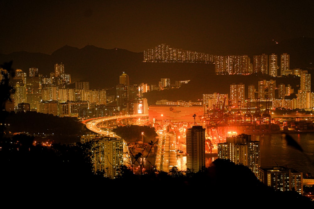 a view of a city at night from a hill