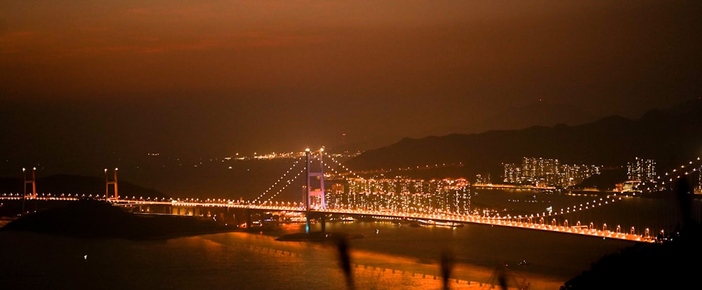 a night view of a bridge over a body of water