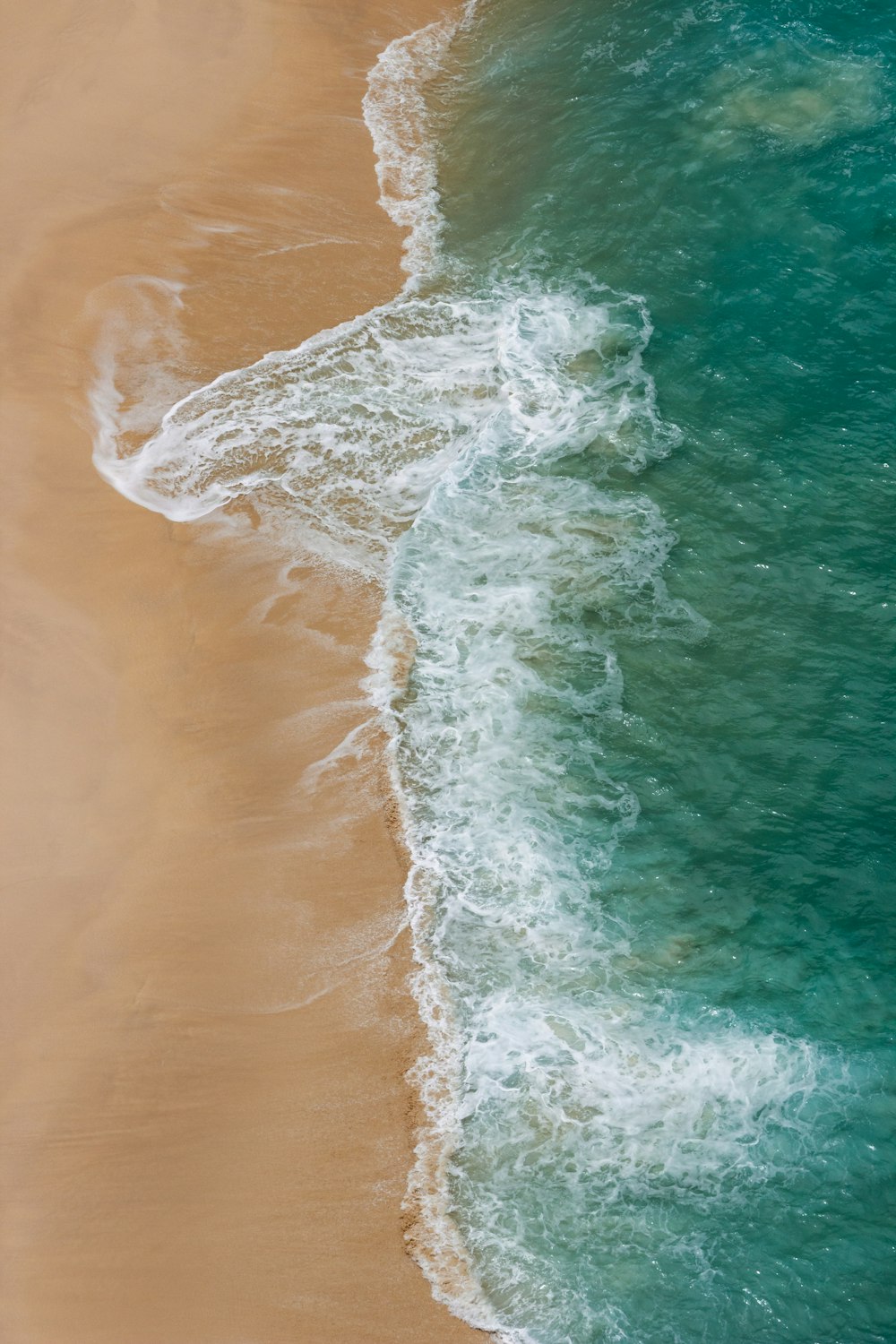 a bird's eye view of a beach and ocean