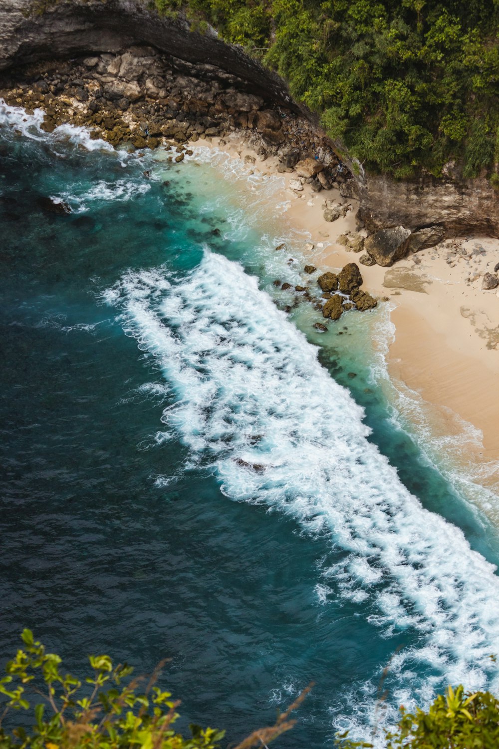 an aerial view of a sandy beach and ocean