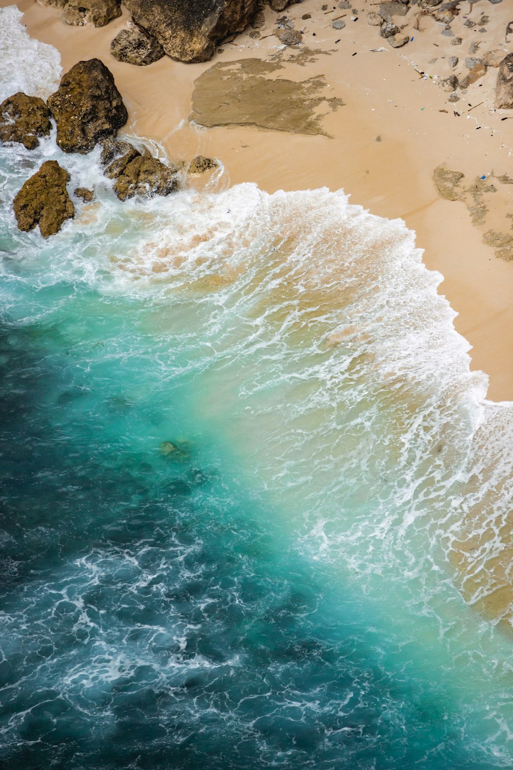 an aerial view of a sandy beach and ocean