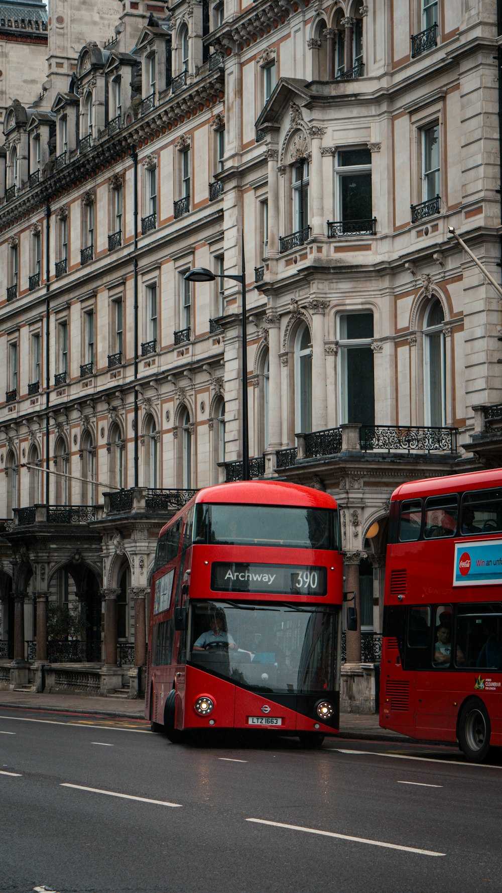 a couple of red double decker buses parked next to each other