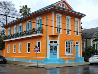an orange and blue building with a blue door